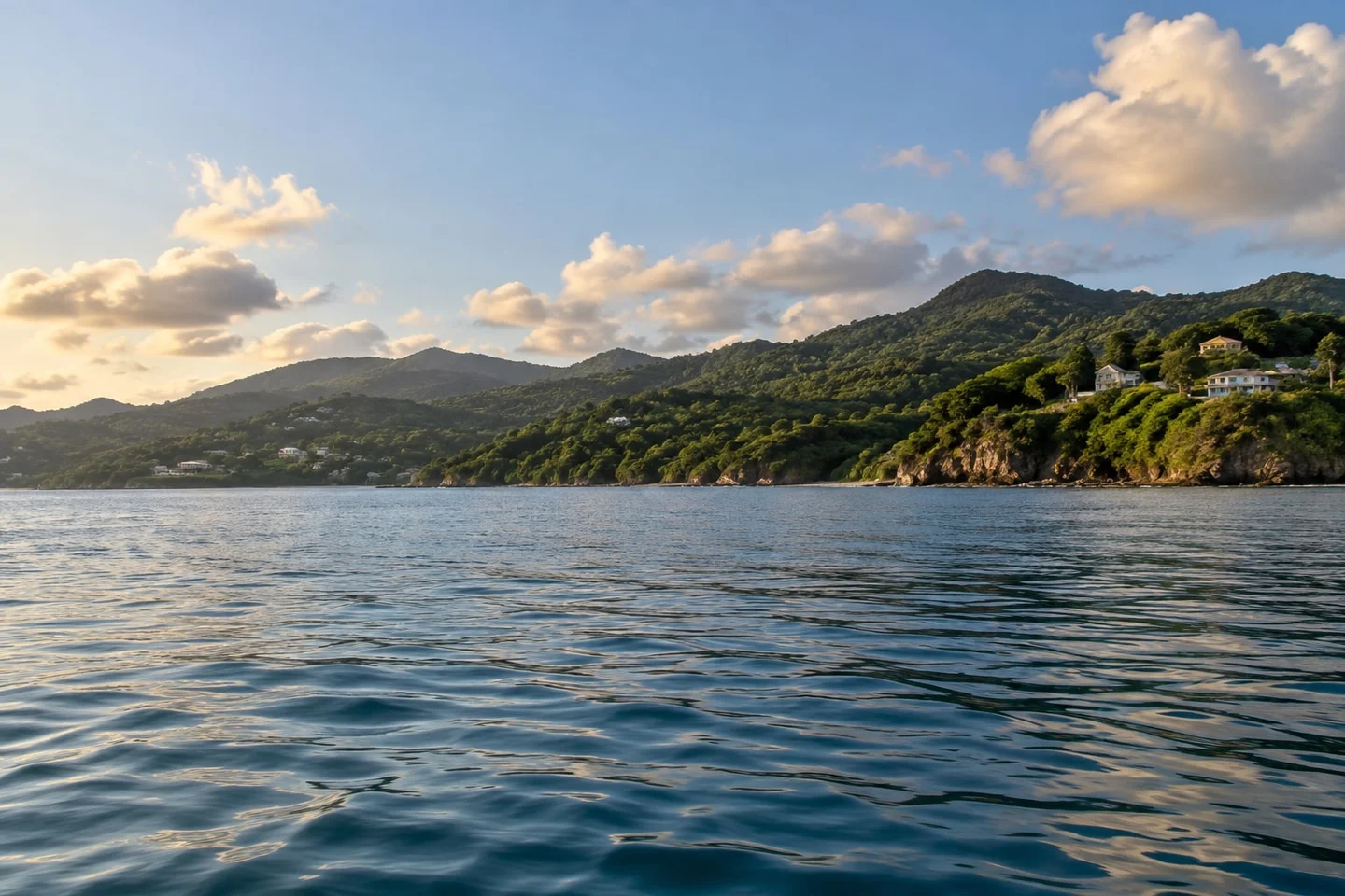 Looking beyond the headline Grenada citizenship price Illustrative view from the water towards a green Caribbean coastline for the Grenada citizenship cost guide