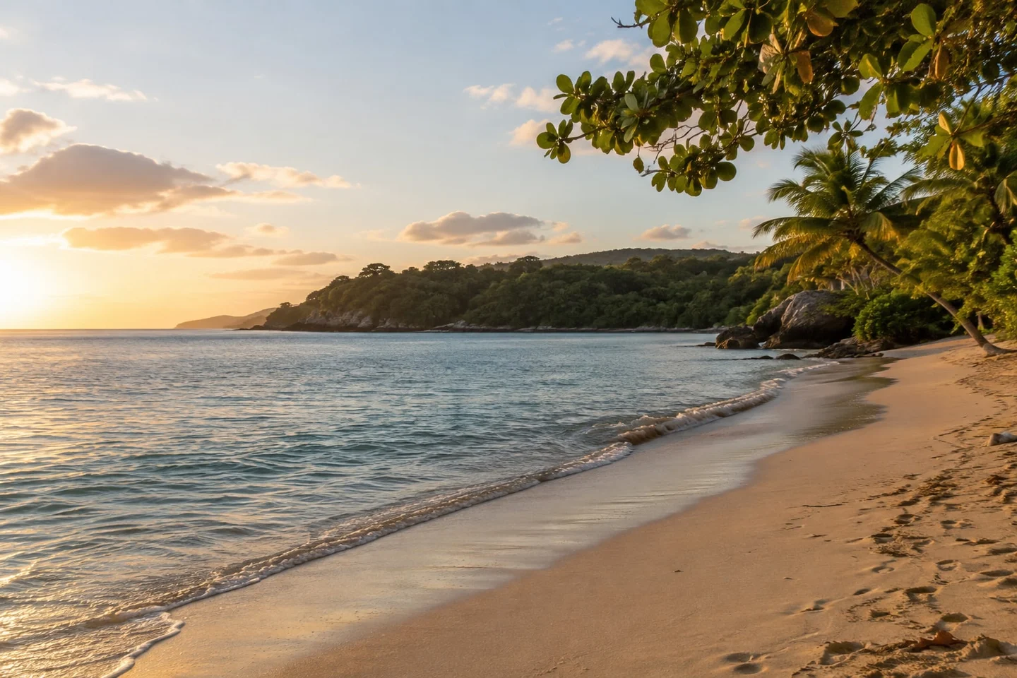 Caribbean coastal living and property planning Illustrative Caribbean beach and green headland in evening light